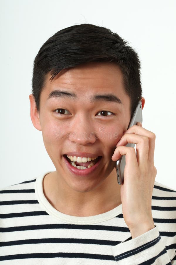 Laughing young Asian man using a smartphone