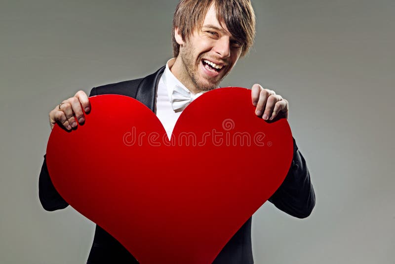 Laughing Young Man Holding a Heart Stock Image Image of celebrating