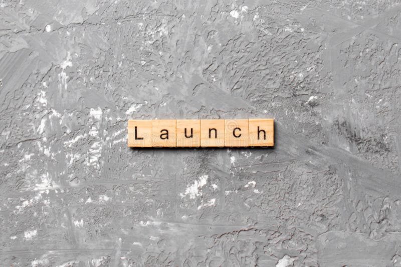 Launch Word Written On Wood Block. Launch Text On Table, Concept Stock