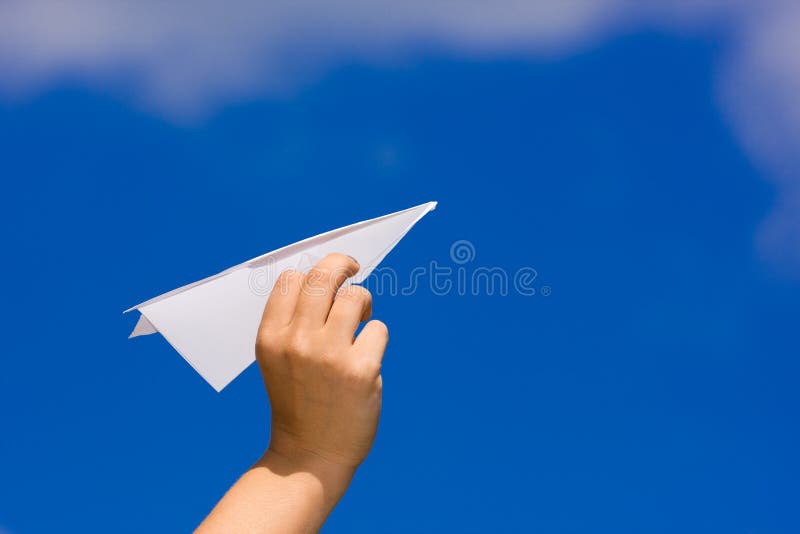 Launching a paper plane over the blue sky