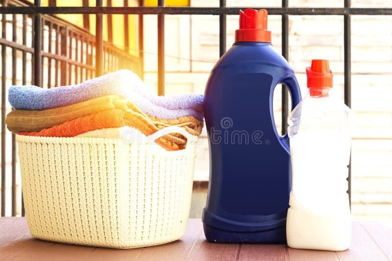 Laundry Detergent Bottle and Basket Stack of Clean Bath Towels on Floor