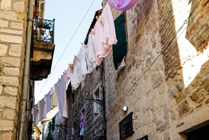 Laundry is dried on arope in the narrow streets of the old town of Kotor, Montenegro, September 2019 royalty free stock photo Laundry is dried on arope in the narrow streets of the old town of Kotor, Montenegro, September 2019 royalty free stock photo