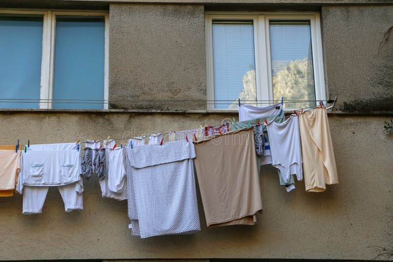 Laundry dries under the windows of a high-rise building stock image Laundry dries under the windows of a high-rise building stock image