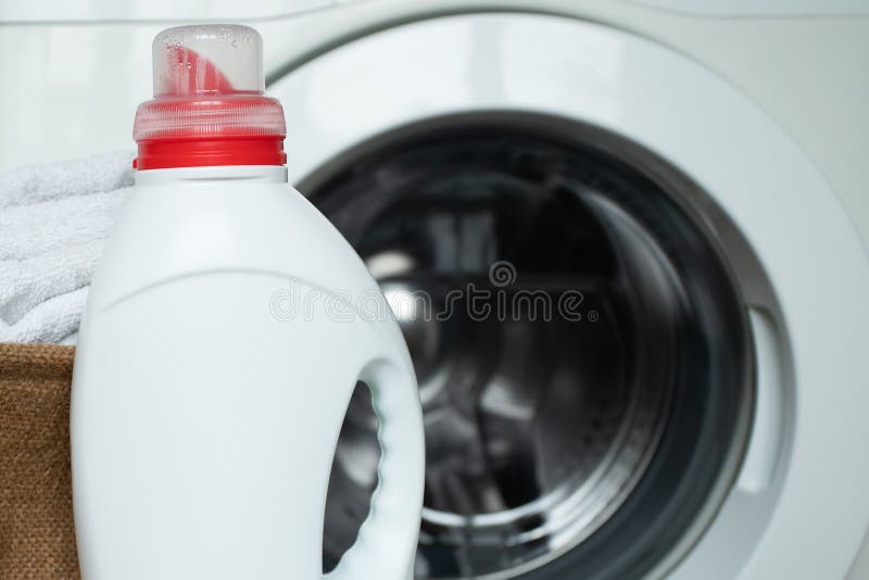 Laundry Liquid Powder and a Washing Machine in the Laundry Room Stock