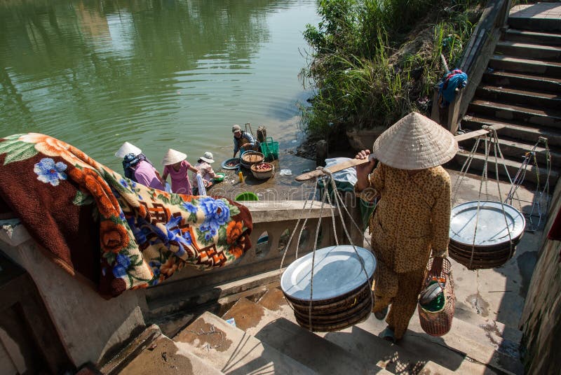 Laundry in the Perfume River, Vietnam. A group of unidentified women do their laundry in the Perfume River on January 12, 2008 in Hue, Vietnam stock photos Laundry in the Perfume River, Vietnam. A group of unidentified women do their laundry in the Perfume River on January 12, 2008 in Hue, Vietnam stock photos
