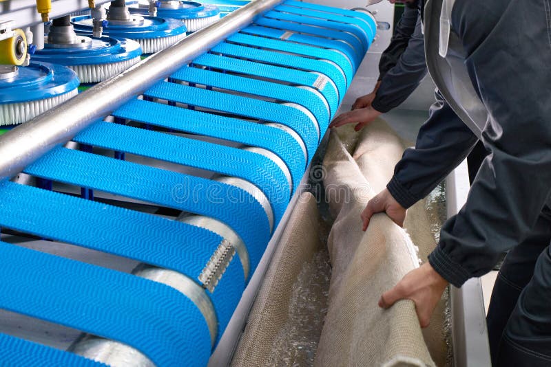 Laundry Worker in the Process of Working on Automatic Machine for