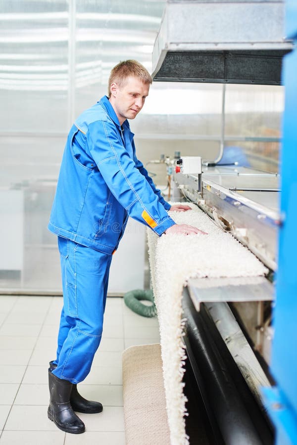 Laundry Worker in the Process of Working on Automatic Machine for