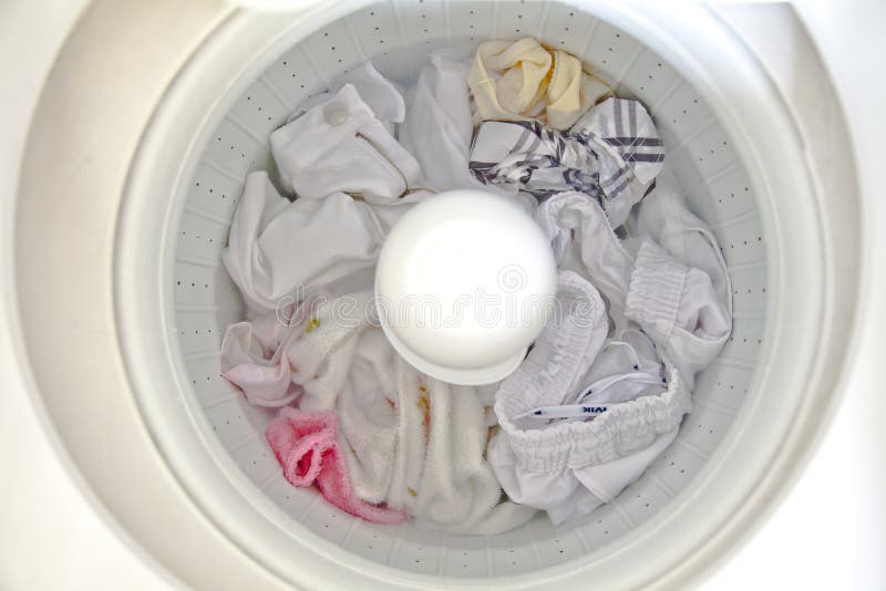 Clothes Washer Being Used To Clean Dirty Clothes and Possibly