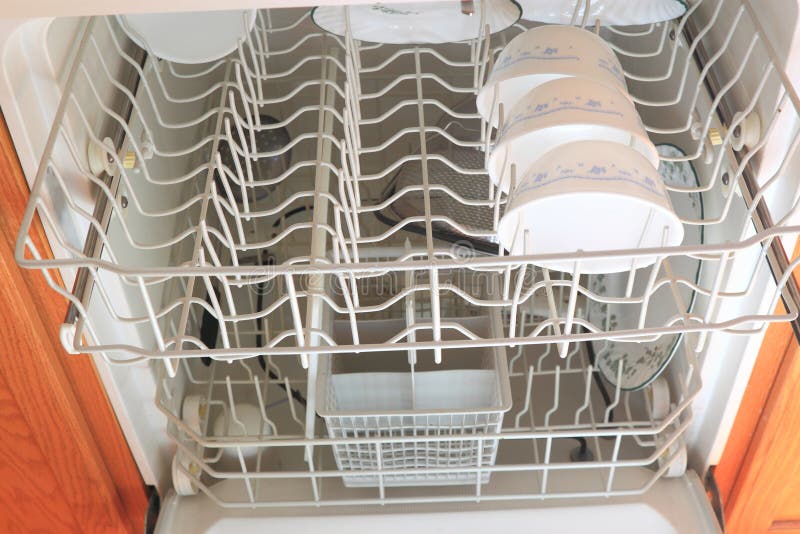 Dish washer inside view with pans and plates on racks. Dish washer inside view with pans and plates on racks.