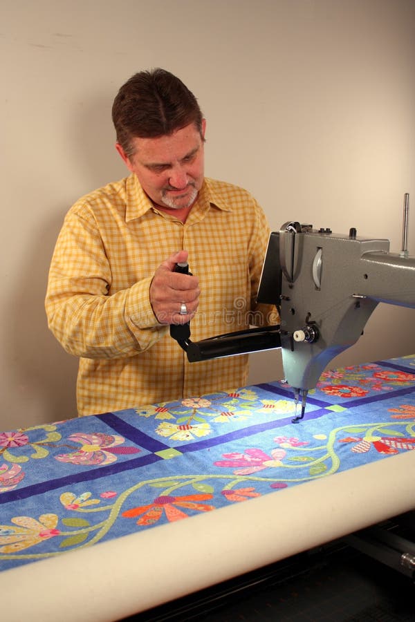 A blue flower quilt on a 12' quilting machine. A blue flower quilt on a 12' quilting machine.