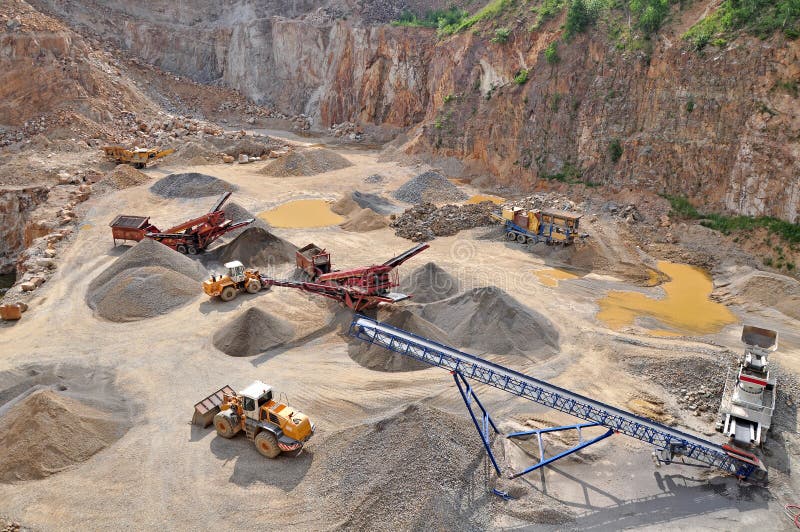 Stone quarry with heavy machines and vehicles, work industry. Stone quarry with heavy machines and vehicles, work industry.