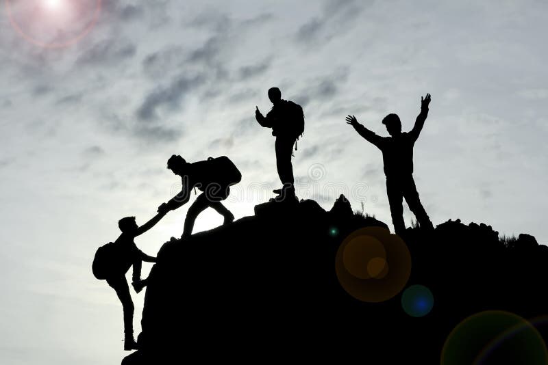 A group of climbers on a mountain, teamwork and success with unity and cooperation concept. A group of climbers on a mountain, teamwork and success with unity and cooperation concept.