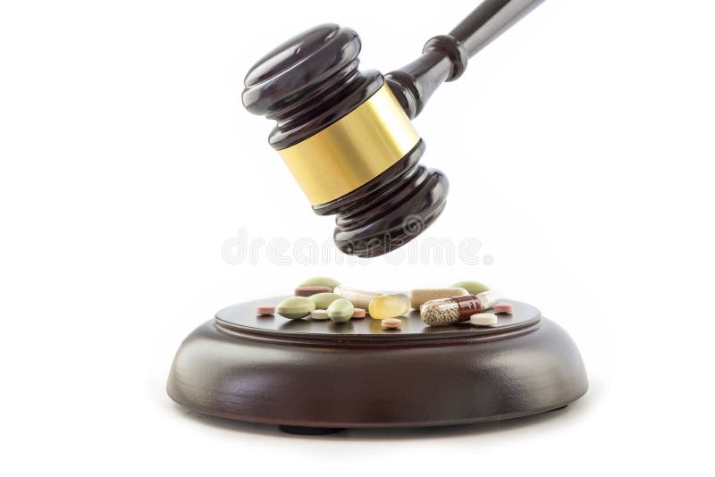Law gavel and drugs, tablets and pills on the wooden sound block royalty free stock photography Law gavel and drugs, tablets and pills on the wooden sound block royalty free stock photography