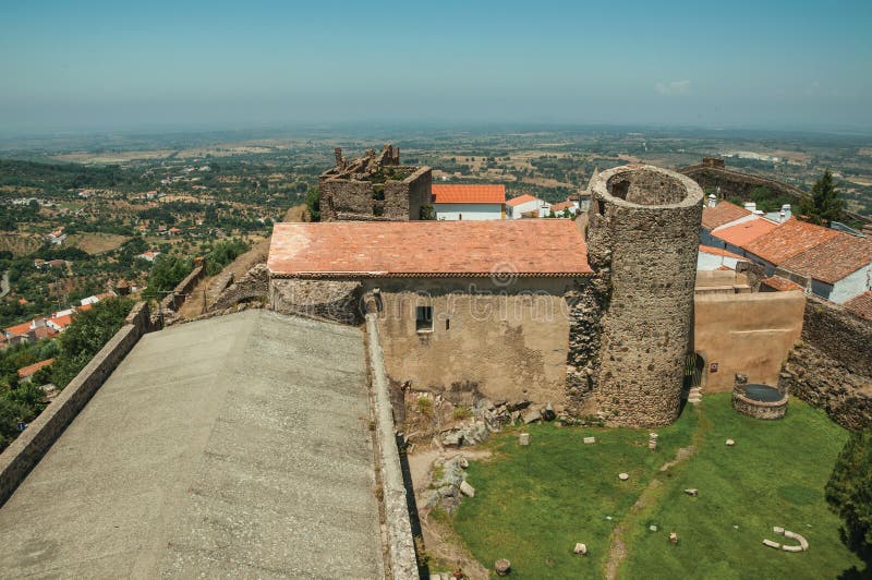 Lawn on castle central courtyard among stone walls and tower