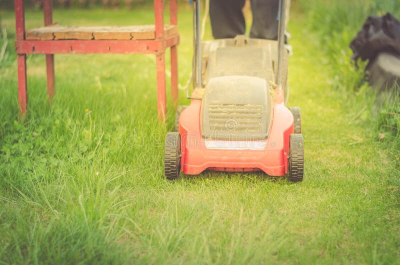 Lawn Mower Cuts a Lawn/red Lawn Mower Cuts a Lawn Stock Photo Image