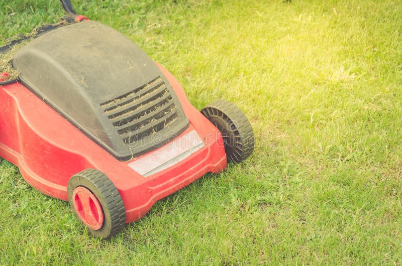 Mowing Lawn on the Grass in the Cottage Yard/mowing Lawn in the Cottage