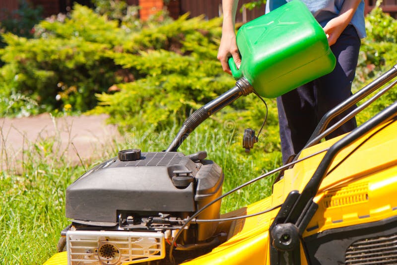 Man Putting Gas into Lawn Mower Over White Stock Photo Image of