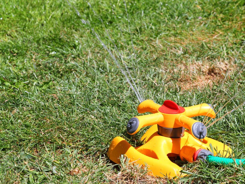Lawn sprinkler watering the grass in a drought. royalty free stock images Lawn sprinkler watering the grass in a drought. royalty free stock images