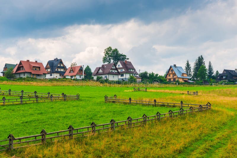 Lawn with wooden fence and villas