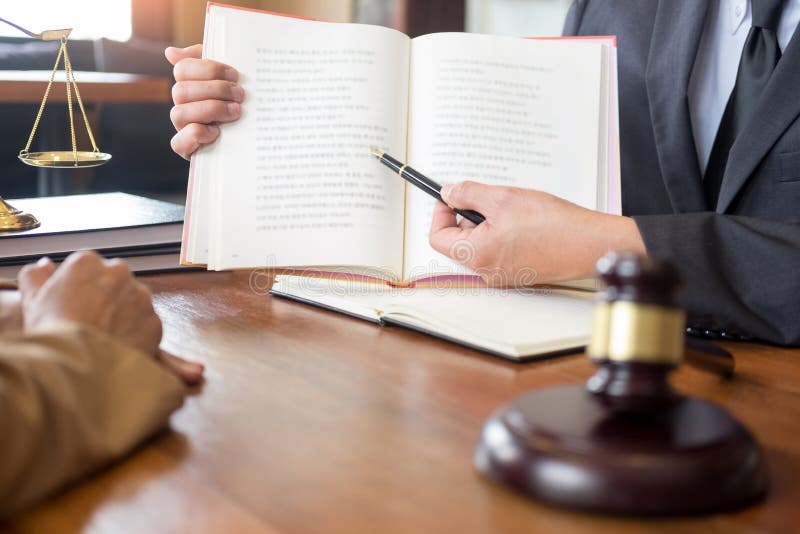 Lawyer in office. Counseling and giving advice about legal legislation in courtroom to help customer, tribunal and justice concept stock photo Lawyer in office. Counseling and giving advice about legal legislation in courtroom to help customer, tribunal and justice concept stock photo