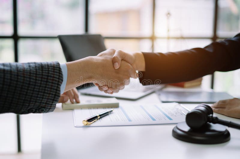 Lawyer Shaking Hands with Client after Discussing Final Contract