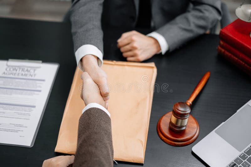 Lawyer Shaking Hands with Client after Discussing Final Contract