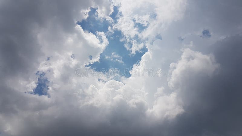 The layer dark and white of clouds in blue sky