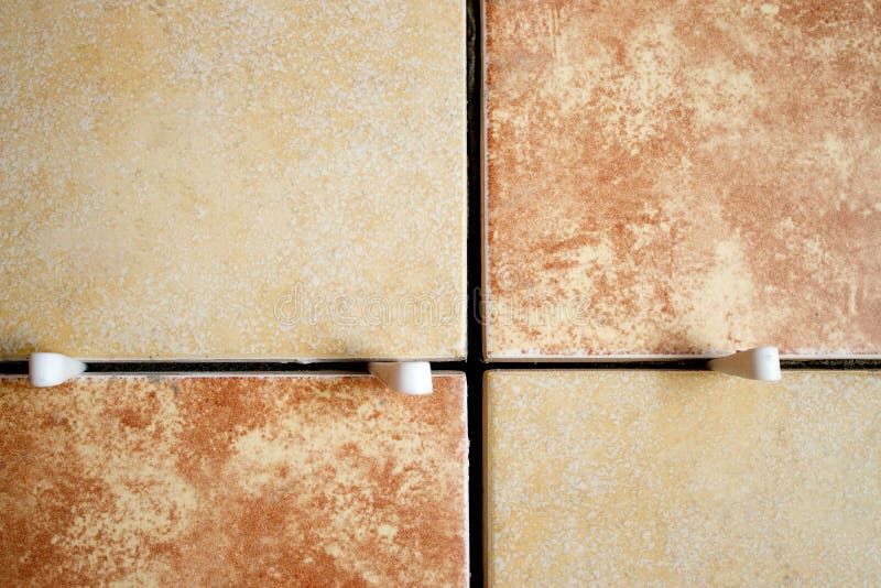 Laying Ceramic Tiles with the Help of Crosses for a Tile by during Wall