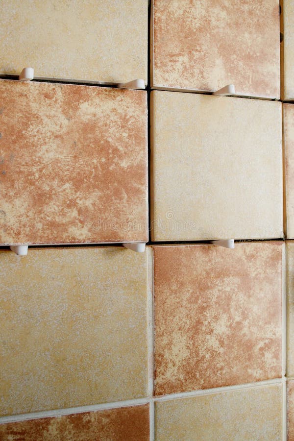 Laying Ceramic Tiles with the Help of Crosses for a Tile by during Wall