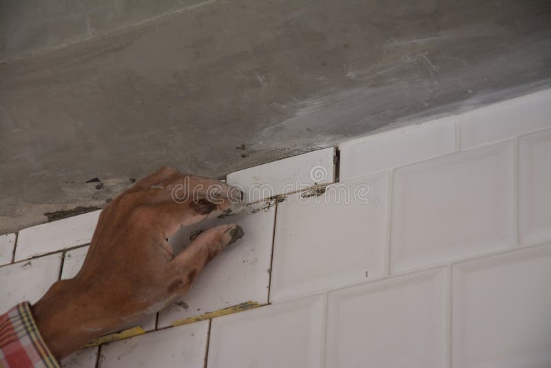Laying Ceramic Tiles on Wall, Installing Tiles in Construction Site