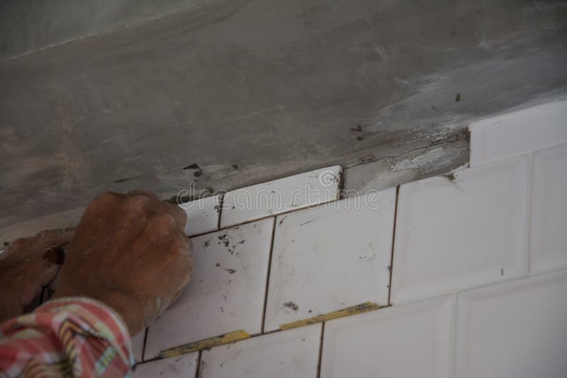 Laying Ceramic Tiles on Wall, Installing Tiles in Construction Site