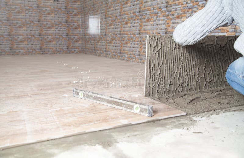 Laying Floor Ceramic Tile. Renovating the Floor Stock Image Image of