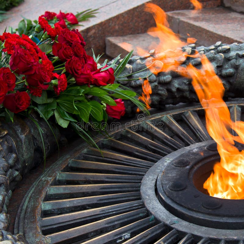 Laying flowers at the quenchless flame dedicated to victory World War II