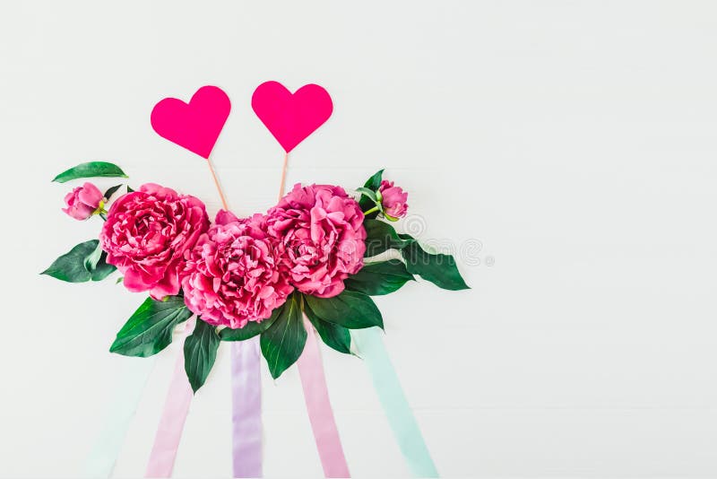 Layout with peony flowers composition, ribbons and two hearts on a white background. Love, Wedding. Valentine`s Floral mockup. royalty free stock photography Layout with peony flowers composition, ribbons and two hearts on a white background. Love, Wedding. Valentine`s Floral mockup. royalty free stock photography