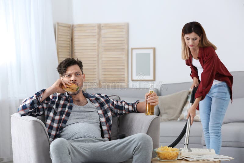 Lazy Husband Lying On Sofa And His Wife Cleaning Stock Image Image Of Couch Couple 124434957 