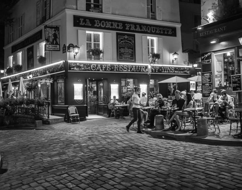 Cobblestone plaza with tables of diners on a late summer evening on Montmartre, in Paris. The famous cafe La Bonne Franquette is in the background. Cobblestone plaza with tables of diners on a late summer evening on Montmartre, in Paris. The famous cafe La Bonne Franquette is in the background.