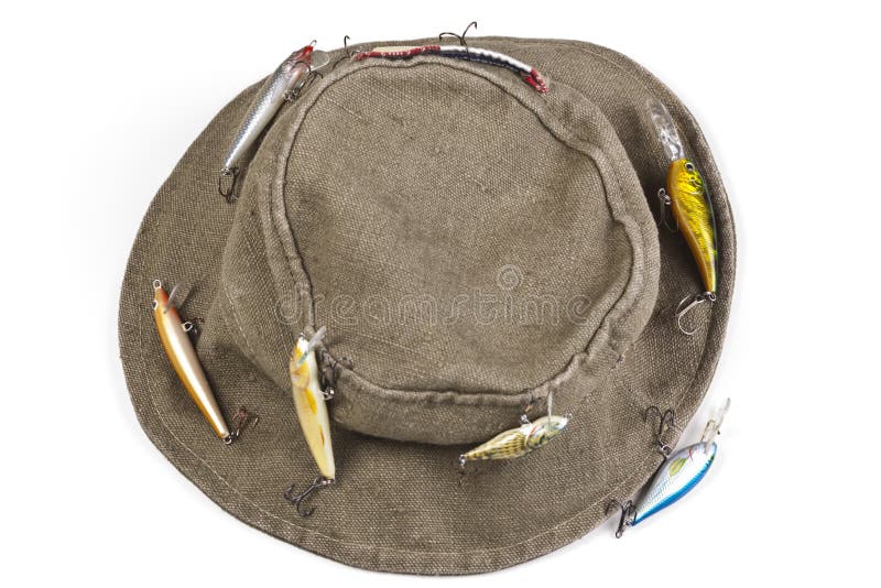 A fisherman's hat with lures attached shot against white background with soft shadow. A fisherman's hat with lures attached shot against white background with soft shadow