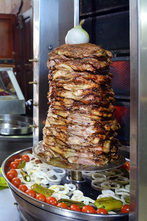 Doner kebab roasted on rotating spit. Food background texture. Doner kebab roasted on rotating spit. Food background texture.