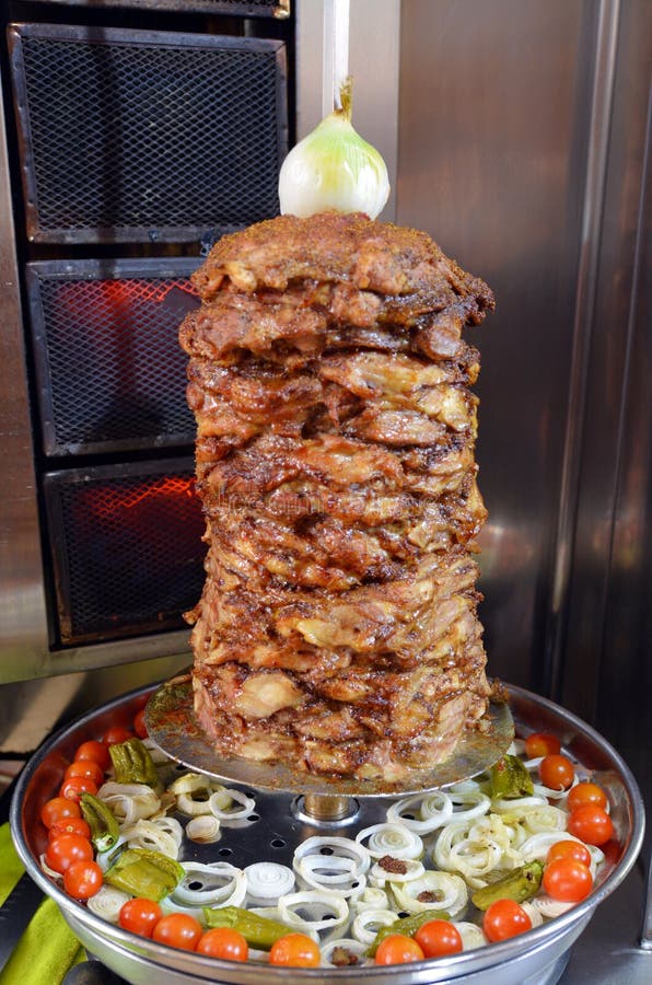 Doner kebab roasted on rotating spit. Food background texture. Doner kebab roasted on rotating spit. Food background texture.