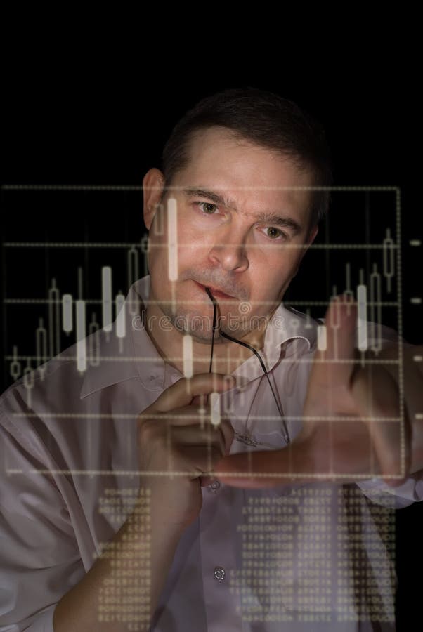 Young man in pink shirt as a trader measures fingers candle stick graph to analyze stock over black background. Young man in pink shirt as a trader measures fingers candle stick graph to analyze stock over black background