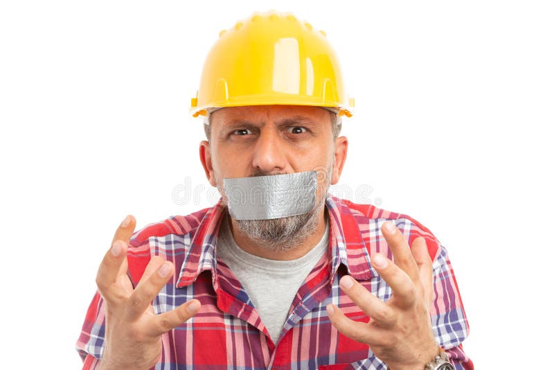 Le constructeur avec la bouche a fermé faire le geste désespéré photo stock Le constructeur avec la bouche a fermé faire le geste désespéré photo stock