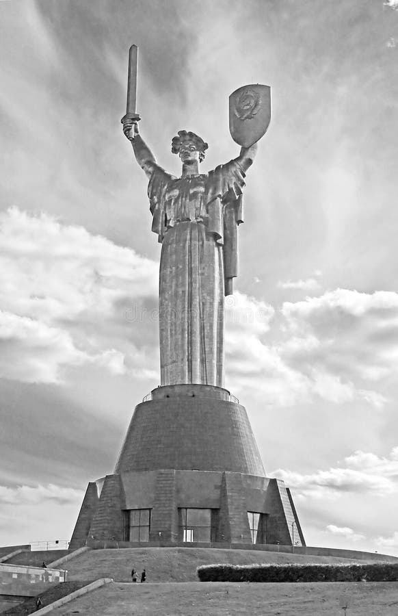 The monument `Mother Motherland` decorated with a wreath of poppies on the Day of Remembrance and Reconciliation in Kyiv, Ukraine. Black and white filter. The monument `Mother Motherland` decorated with a wreath of poppies on the Day of Remembrance and Reconciliation in Kyiv, Ukraine. Black and white filter
