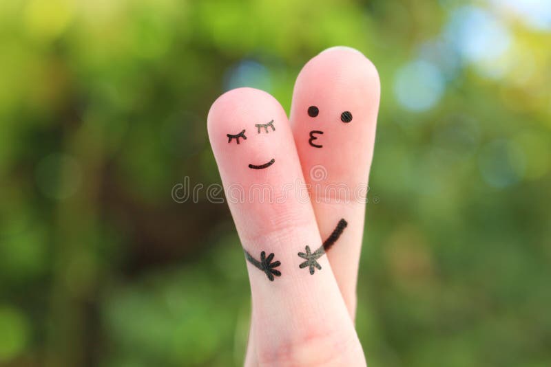 Fingers art of Happy couple. Man hugs and kisses woman. Fingers art of Happy couple. Man hugs and kisses woman.