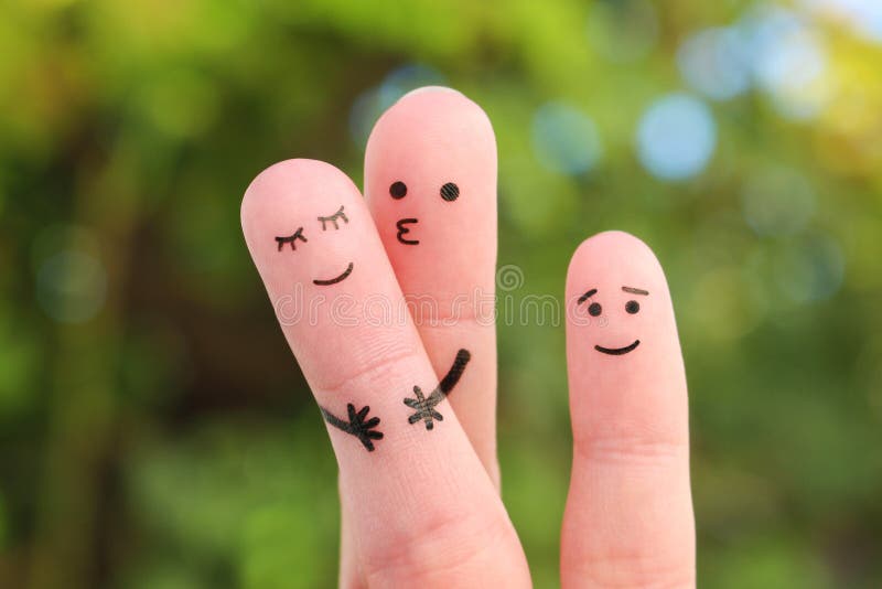 Fingers art of happy family. Concept of couple kissing, child is happy. Fingers art of happy family. Concept of couple kissing, child is happy