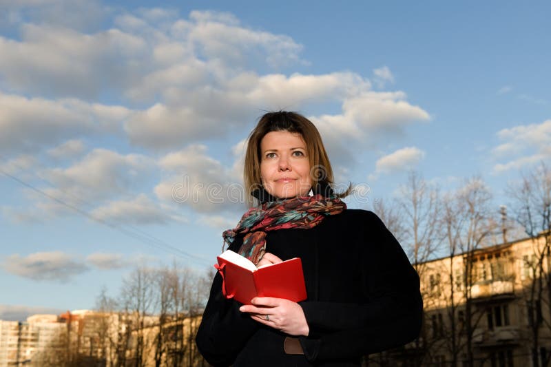 Le femme vêtx en automne avec un livre image libre de droits Le femme vêtx en automne avec un livre image libre de droits