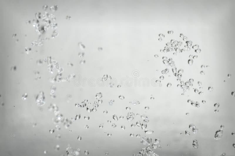 Le fond abstrait, gouttes de l'eau éclaboussent dans le ciel sur un fond clair Belle forme intéressante images libres de droits Le fond abstrait, gouttes de l'eau éclaboussent dans le ciel sur un fond clair Belle forme intéressante images libres de droits