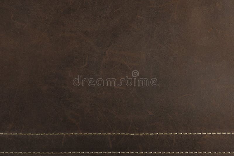 Le fond et la texture de cuir de Nubuck de brun foncé