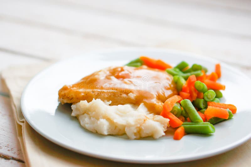 Le four a fait le poulet cuire au four en sauce au jus avec de la purée de pommes de terre et les légumes photographie stock Le four a fait le poulet cuire au four en sauce au jus avec de la purée de pommes de terre et les légumes photographie stock