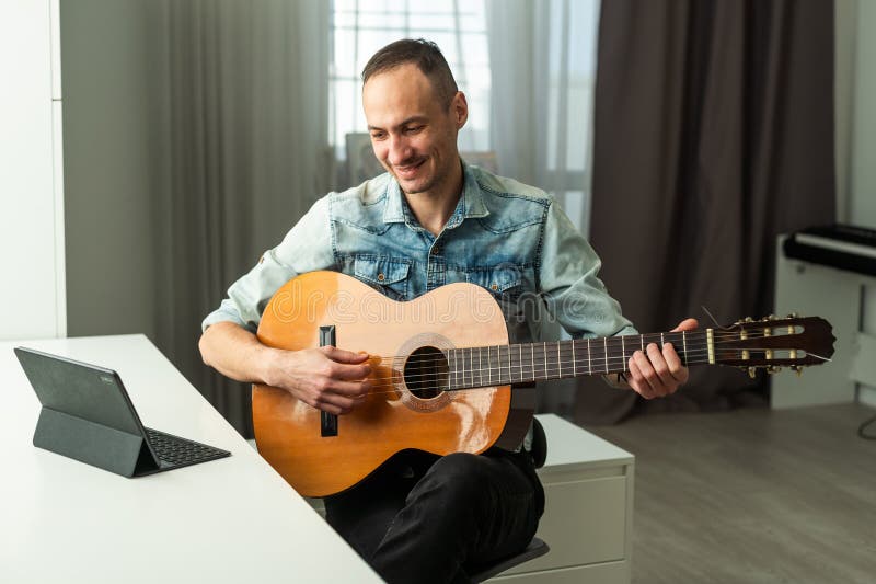 Le gars en direct live records podcasts joue de la guitare. Il communique avec les gens sourient et gère sa propre musique photos libres de droits