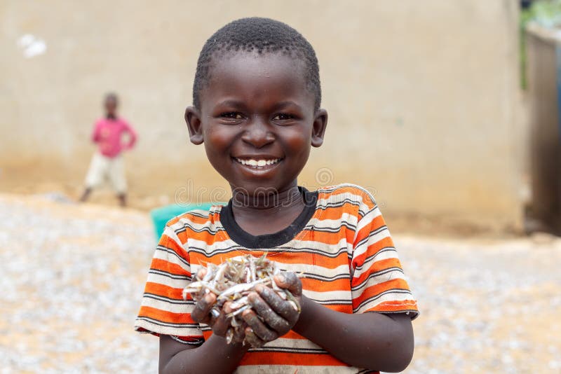 A boy holds a handful of fish known as omena around the Lake Victoria region of East Africa. A boy holds a handful of fish known as omena around the Lake Victoria region of East Africa.